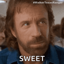 a man with a beard and a blue shirt is saying sweet .