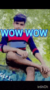 a young man is sitting on a rock with the words wow wow written on it