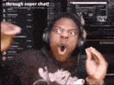 a man wearing headphones and a shirt that says ' through super chat '