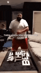a man is dancing in a living room with the words `` them when you hop on the game '' written above him .