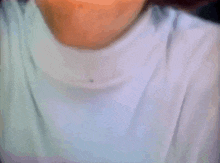 a close up of a person 's face with a white shirt