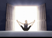 a woman is sitting in a doorway with her legs crossed