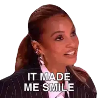 a woman in a suit and tie is smiling and says it made me smile