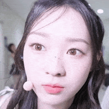 a close up of a woman 's face with a small star on her nose