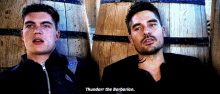 two men are sitting next to each other and one of them says thundart the barbarian