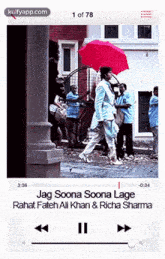 a video of a man holding an umbrella is being played on a cell phone .