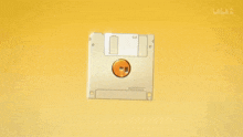 a floppy disk with a yellow circle on it