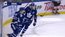 two toronto maple leafs players celebrate a goal