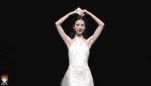 a woman in a white dress is dancing on a stage