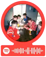 a group of young men sit around a table in a red circle with a spotify logo