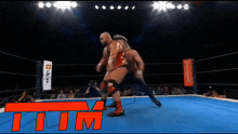 two men are wrestling in a ring with the word tim on the bottom right
