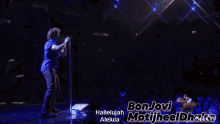 a man singing into a microphone with the words bon jovi motifheel dhaka below him