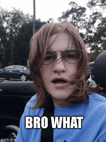 a young man wearing glasses and a blue shirt with the words bro what on it