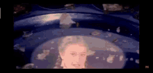 a close up of a woman 's face in a bubble in a pool .