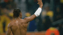 a shirtless athlete with a wristband on his wrist