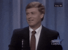 a man in a suit and tie is speaking into a microphone with 2004vote cspan2 written on the screen behind him
