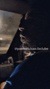 a man with a beard is sitting in a car with pabloeluisao.facclube written below him