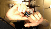 a person is holding a cube in their hands with the letter l on the bottom