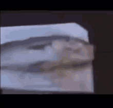 a blurry picture of a person 's face is being projected on a wall .