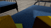 a blue carpeted floor with a few beds in the background