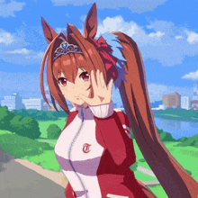 a horse girl with a tiara on her head is wearing a jacket with the letter t on it
