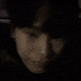 a close up of a person 's face making a funny face in the dark .