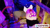 a picture of a zombie hanging upside down with a kapwing logo below it