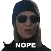 a woman wearing sunglasses and a hat has the word nope written on her face
