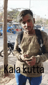 a man with a backpack is looking at his phone and the words kala kutta are below him