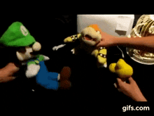 a group of stuffed animals are sitting on a table .