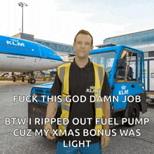 a man wearing a klm shirt stands in front of a klm plane