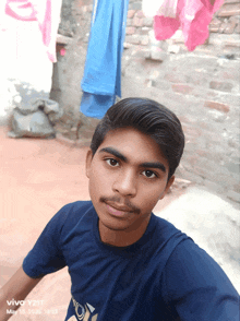 a young man taking a selfie with a vivo y2ii phone