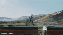 a man is jumping off the side of a train with the hashtag pranay_varma below him