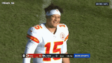 a football player with the number 15 on his jersey stands on the field