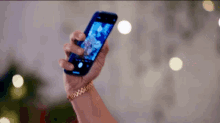 a man and a woman are taking a selfie with a bride and groom .