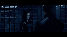 a man in a black turtleneck is holding a sword