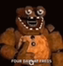 a close up of a teddy bear in a dark room with a smile on his face .