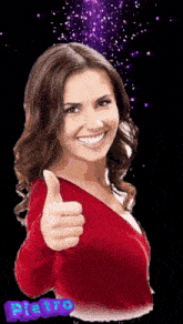 a woman is smiling and giving a thumbs up