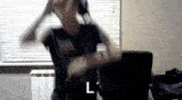 a blurry picture of a person with the letter l in the lower right corner