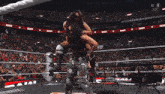 a woman in a wrestling ring with the word win on the bottom right
