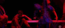 a woman in a blue dress is dancing on a stage in front of a sign that says ' i love you ' on it