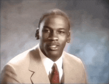 a man wearing a suit and tie looks at the camera