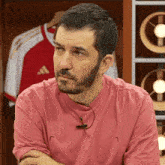 a man in a pink shirt with the letter l on the front