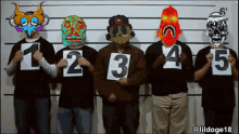 a group of men holding up signs with the numbers 1 2 3 4 5 on them