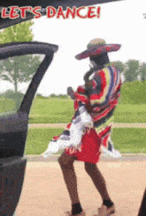 a man in a sombrero and a poncho is dancing in the back of a car .