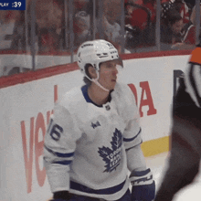 a hockey player wearing a jersey that says toronto maple leafs on it