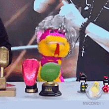 a bunch of stuffed animals are on a table with a recordtv logo