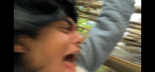 a close up of a person 's face with their mouth wide open