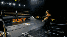 a wrestling ring with a sign that says nxt