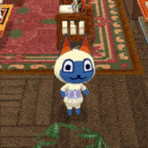 a blue and white cat is standing on a wooden floor in a living room